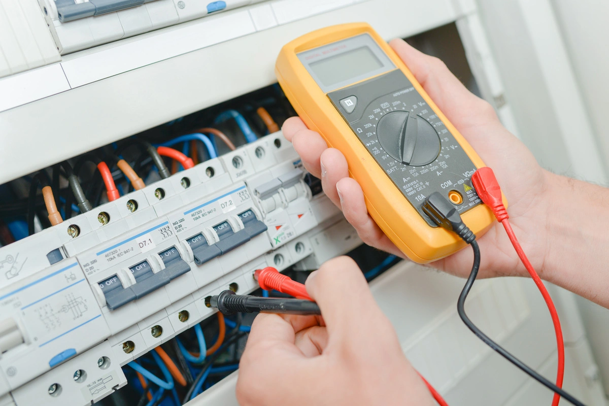 Électricité générale : vérification de disjoncteurs dans un tableau électrique